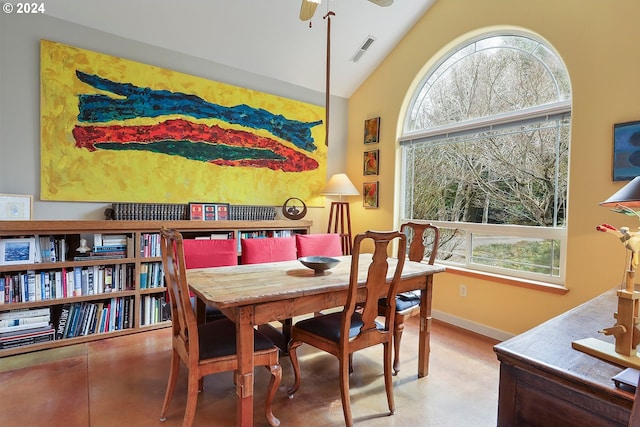 dining space with ceiling fan and lofted ceiling