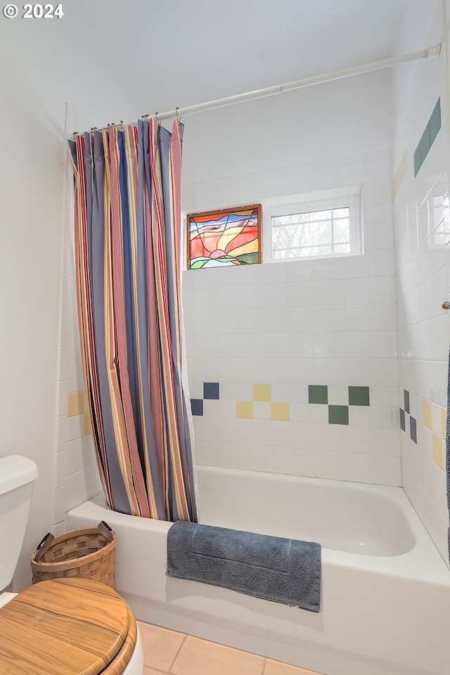 bathroom with tile floors, toilet, and shower / bath combo