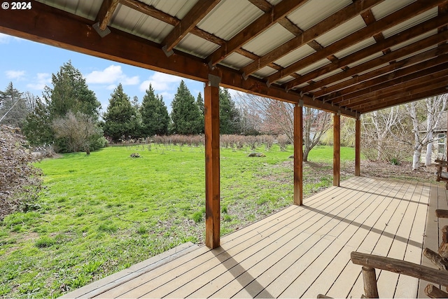 wooden terrace featuring a lawn