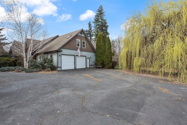 view of side of home featuring a garage