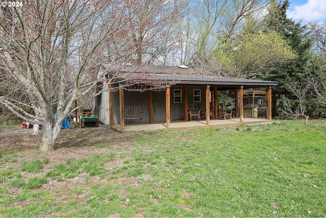 rear view of house with a yard