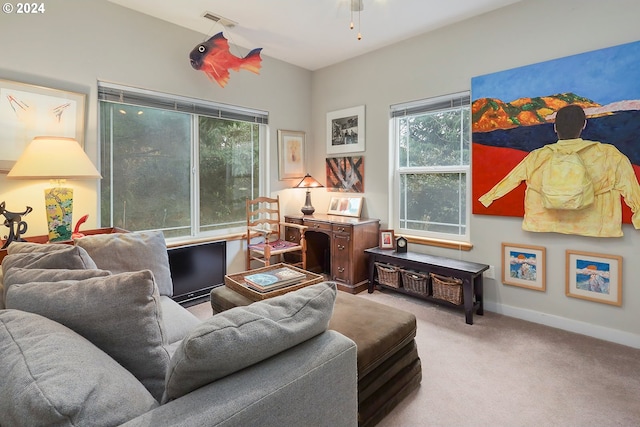 carpeted living room with ceiling fan