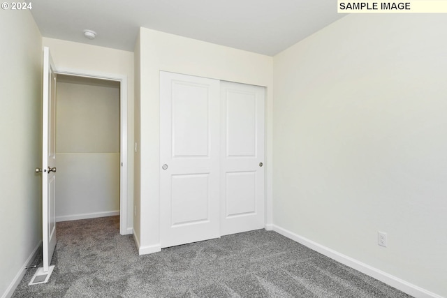 3915 SW Duniway Ln, Gresham, OR 97080 - unfurnished bedroom with dark carpet, a closet, and baseboards