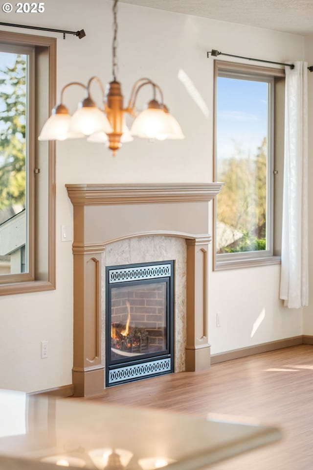 details featuring a tile fireplace and a chandelier