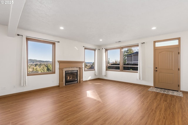 unfurnished living room featuring wood-type flooring