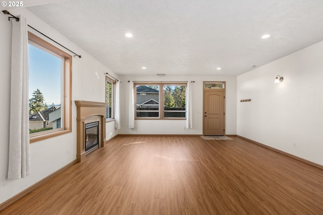 unfurnished living room with light hardwood / wood-style floors