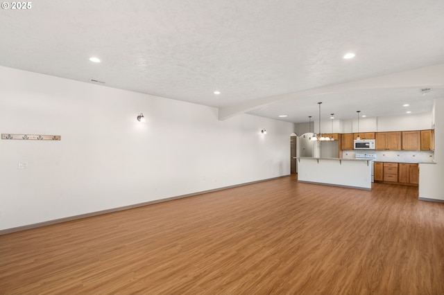 unfurnished living room featuring hardwood / wood-style flooring