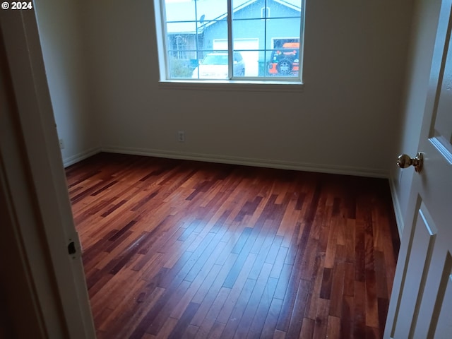 spare room featuring dark hardwood / wood-style flooring