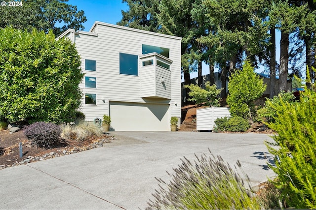 view of property exterior featuring a garage and driveway