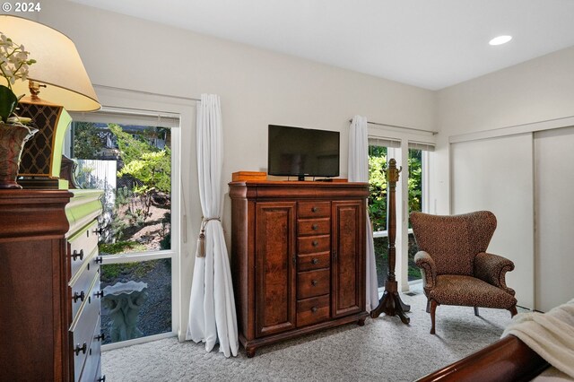 living area with light carpet and recessed lighting