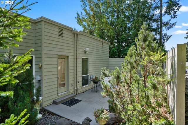 back of house with a patio area and fence