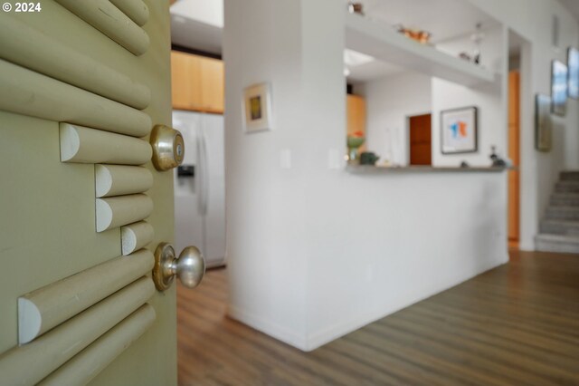 interior space with baseboards, stairway, and dark wood finished floors