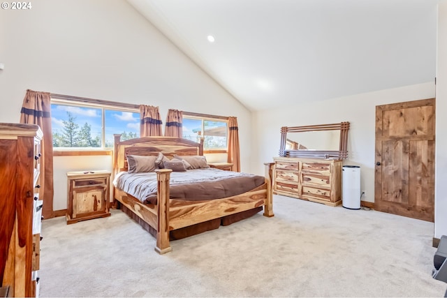 carpeted bedroom featuring high vaulted ceiling