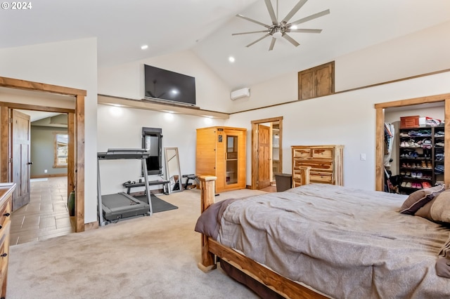 carpeted bedroom featuring an AC wall unit, high vaulted ceiling, ceiling fan, and a walk in closet