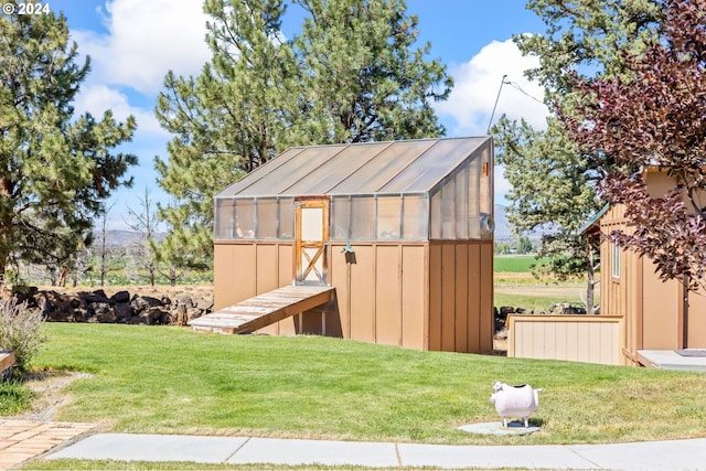 view of outbuilding with a yard