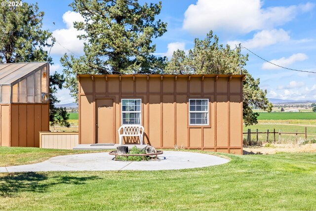 view of outbuilding featuring a lawn