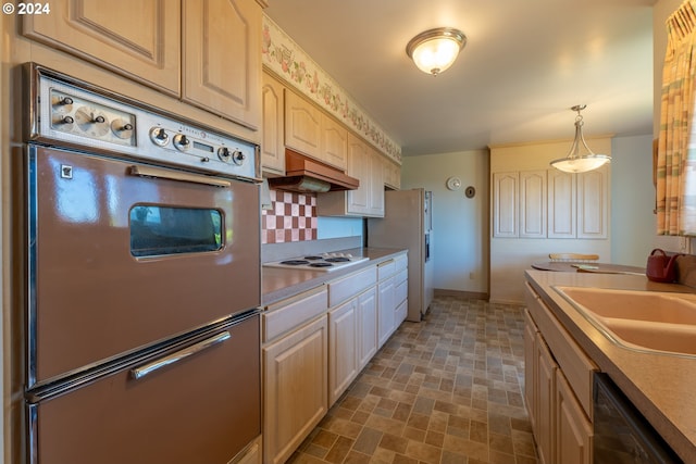 kitchen featuring white appliances, custom exhaust hood, decorative backsplash, decorative light fixtures, and sink