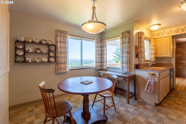 dining room with light hardwood / wood-style floors and sink