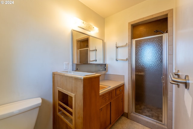 bathroom featuring vanity, walk in shower, and toilet