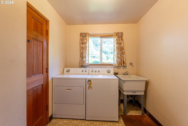 laundry area featuring washer and clothes dryer and light tile patterned floors