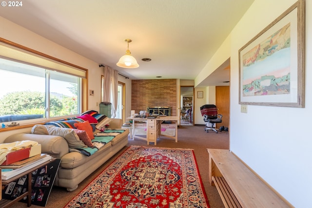 living room with brick wall, a brick fireplace, and carpet flooring