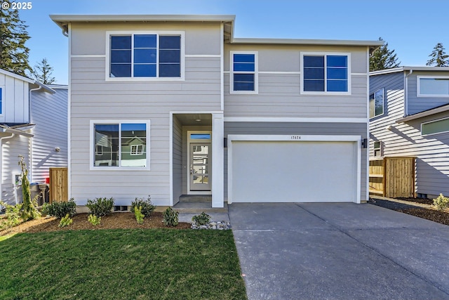 view of front of house with a front yard and a garage