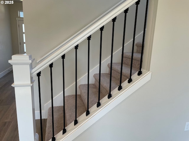 staircase with hardwood / wood-style floors