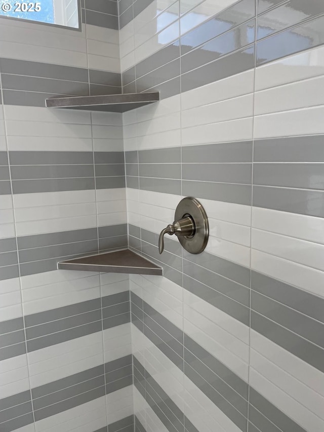 interior details with a tile shower