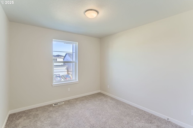 unfurnished room featuring light carpet