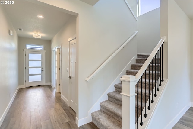 stairway featuring hardwood / wood-style floors