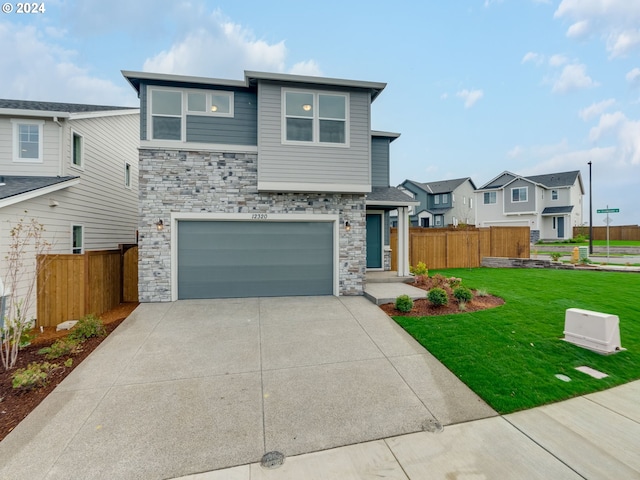 view of front of property with a front yard and a garage