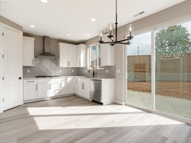 kitchen featuring white cabinetry, wall chimney exhaust hood, and appliances with stainless steel finishes