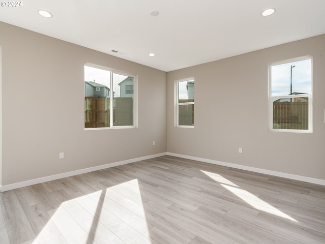 spare room featuring plenty of natural light and light wood-type flooring