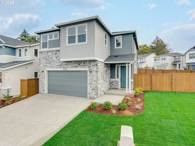 view of front of home featuring a front lawn and a garage