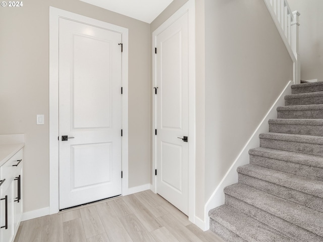 stairs with hardwood / wood-style floors