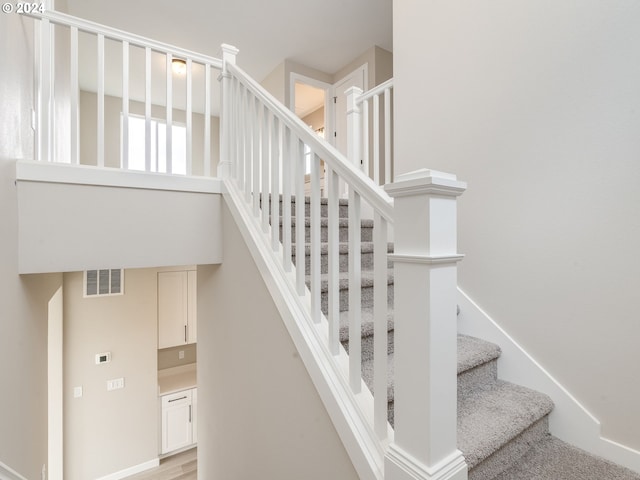 staircase featuring wood-type flooring