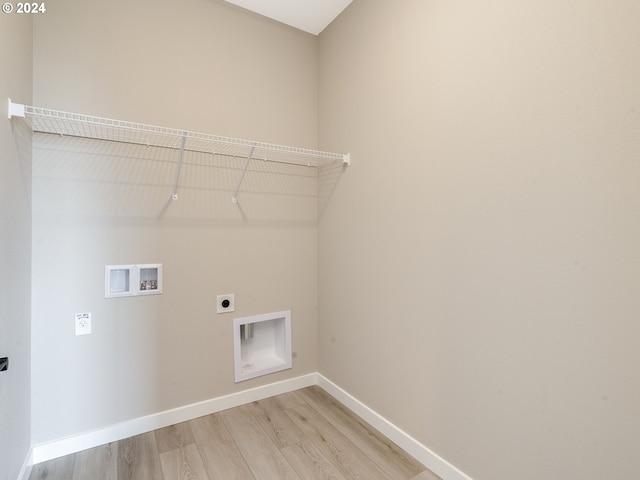 laundry room with hookup for a washing machine, light hardwood / wood-style floors, and electric dryer hookup