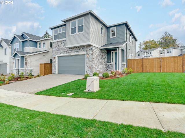 view of front of house featuring a garage and a front yard