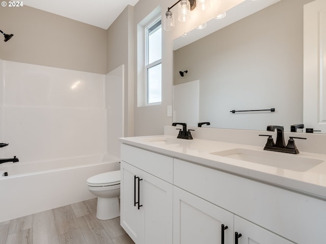 full bathroom with shower / washtub combination, toilet, vanity, and hardwood / wood-style flooring