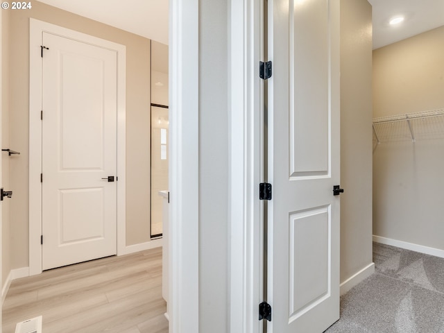 hall with light wood-type flooring