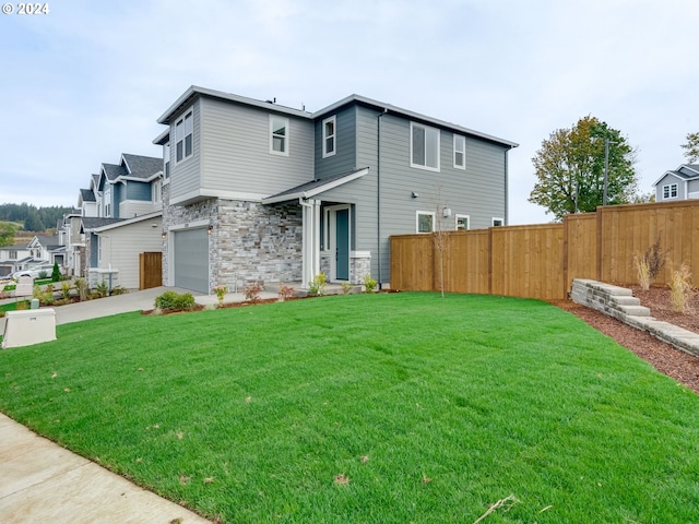 exterior space featuring a lawn and a garage