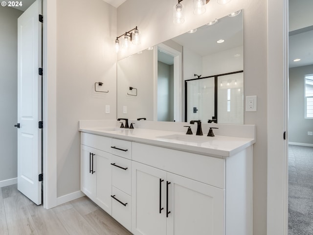 bathroom featuring hardwood / wood-style floors, vanity, and walk in shower