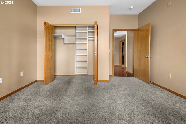 unfurnished bedroom featuring carpet flooring and a closet