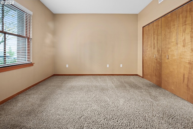 unfurnished bedroom with carpet and a closet