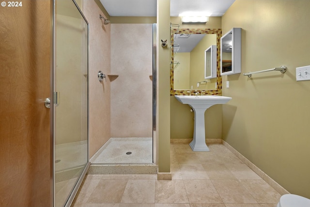 bathroom featuring tile patterned flooring and an enclosed shower