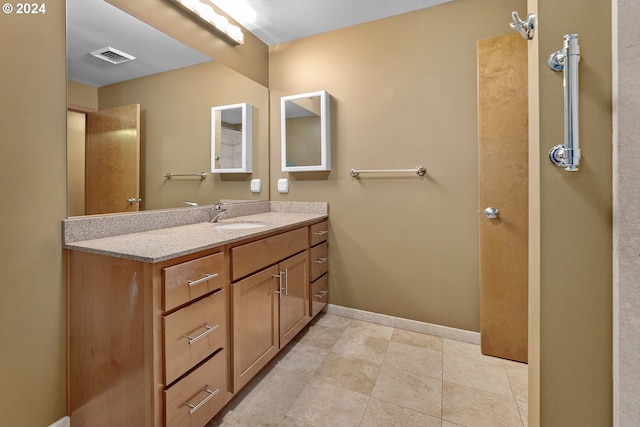 bathroom featuring tile patterned flooring and vanity