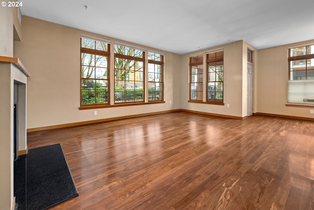 unfurnished living room with hardwood / wood-style floors