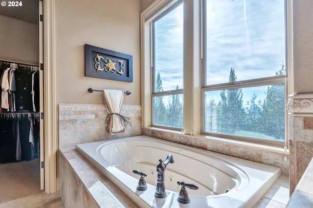 bathroom with a relaxing tiled tub