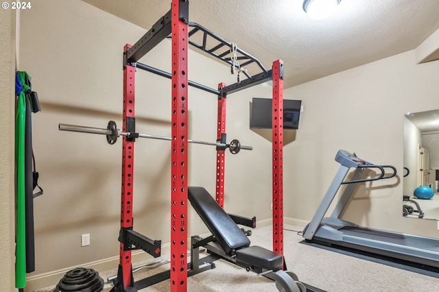 workout room featuring a textured ceiling