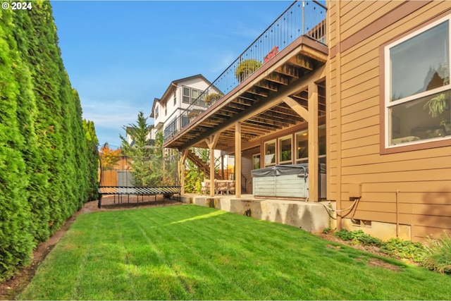 view of yard featuring a hot tub and a wooden deck